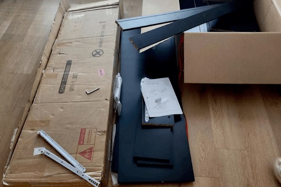 Dresser panels and packaging laid out on a wood floor