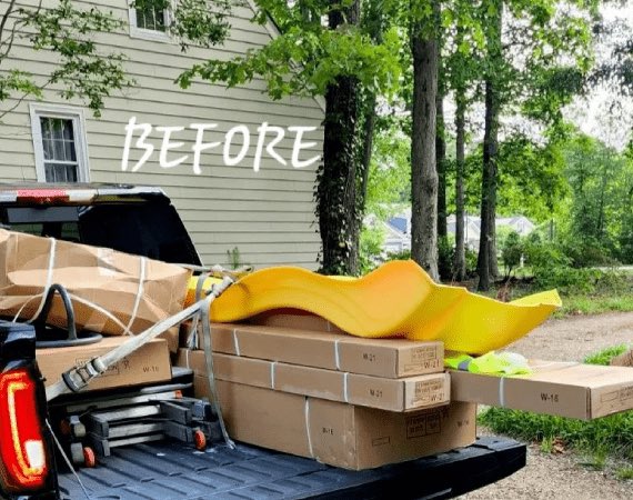 Playset boxes and a yellow slide in the bed of a pickup truck